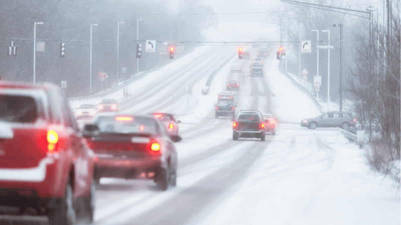 cars with working dipped headlights during poor weather condition