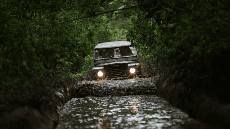 The off-road vehicle struggled forward on the rough road.