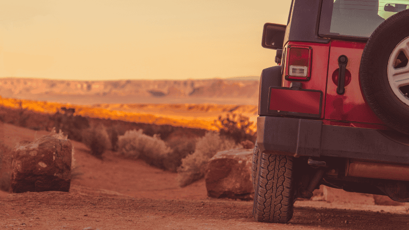An off-road vehicle is driving in the desert