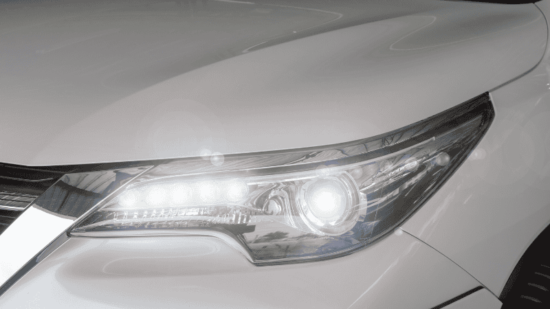 A detailed display of the white car's headlights