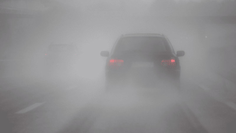 In this fog, you can't see the road, and you can see distinct fog light beams