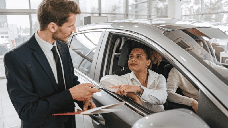 The vehicle salesperson is introducing the vehicle to the customer
